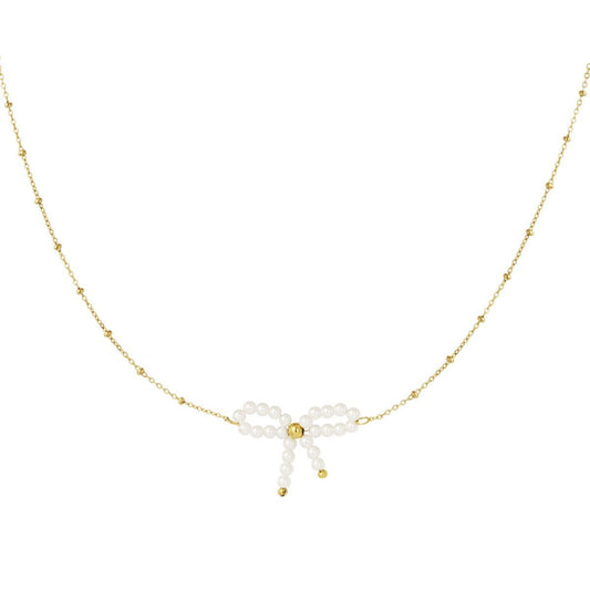 Elegante gouden ketting met een strikje en parel hangertje